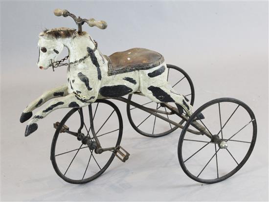 A 19th century French wrought iron and carved and painted velocipede modelled as a horse, overall length 36in. height 27in.
